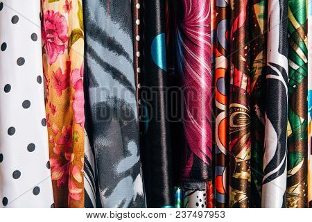 Different Types Of Fabrics Are Folded Neatly In A Row