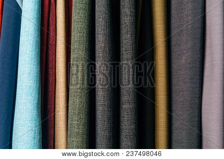 Different Types Of Fabrics Are Folded Neatly In A Row