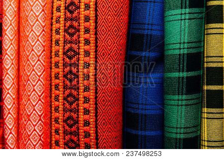 Different Types Of Fabrics Are Folded Neatly In A Row