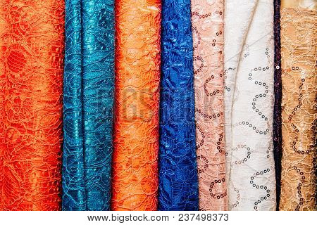 Different Types Of Fabrics Are Folded Neatly In A Row