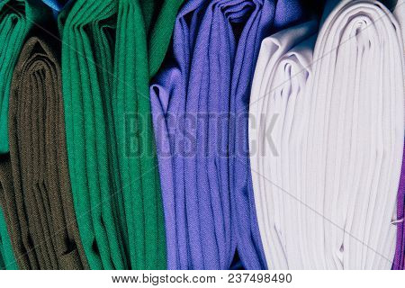 Different Types Of Fabrics Are Folded Neatly In A Row
