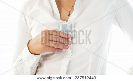 Closeup Image Of Sexy Young Woman Taking Condom Out Of Her Decolette