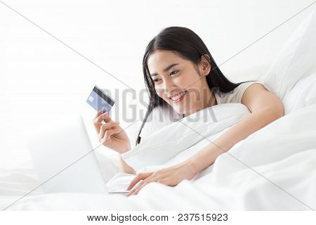 Attractive Asian Woman Using Credit Card For Online Shopping Chat At Home. People With Lifestyle Con