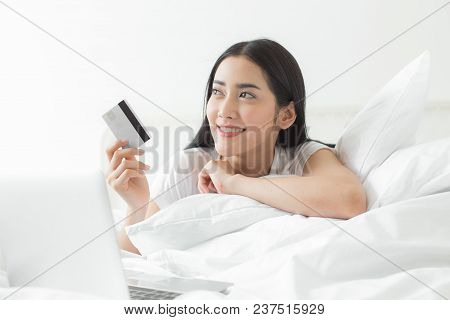 Attractive Asian Woman Using Credit Card For Online Shopping Chat At Home. People With Lifestyle Con