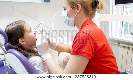 Portrait Of Teengirl Visiting Dentist In Dental Office