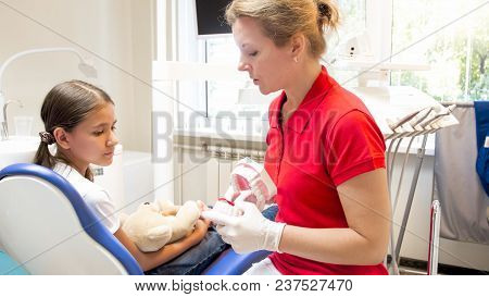 Pediatric Dentist Explaining Teeth Treating To Her Patient