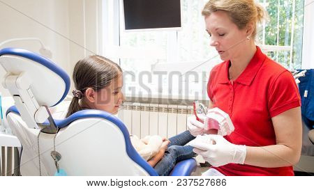 Female Pediatric Dentist Educating Her Patient About Tooth Hygiene