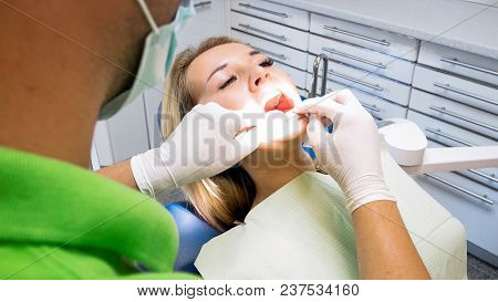 Closeup Photo Of Young Woman Open Mouth For Theeth Checkup