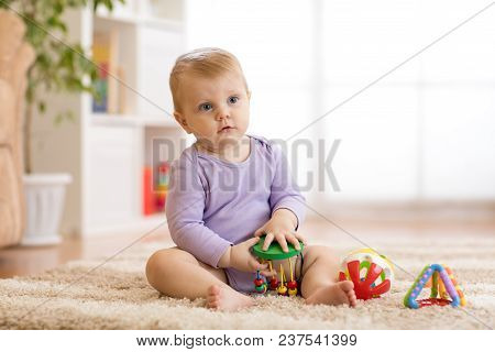 Cute Baby Girl Playing Educationa Toys At Home Or Kindergarten