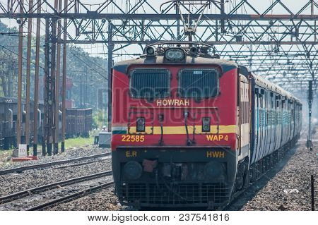 Kolkata, India - 4 March 2018: Express Train Pulled By An Electric Locomotive Engine Traveling Towar