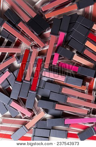 A Bunch Of Bright Red Bor, Red, Pink Lipsticks Lip Gloss On White Background, Top View, Cosmetic.