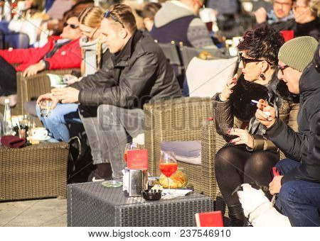 Trieste, Italy - Dicember, 12: Senior Couple Sitting At A Table In A Outdor Cafe On Dicember 12, 201