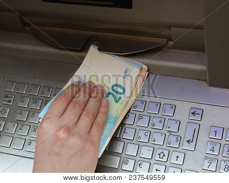 Hand Takes A Lot Of Money From An Atm With Euro Currency And The Keyboard Of The Electronic Machine