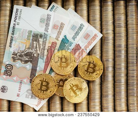 Gold Krypto Coins Bitcoin Btc, Paper Notes Of Russian Rubles. Metal Coins Are Laid Out In A Smooth B