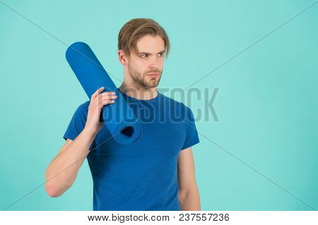 Sportsman Hold Yoga Mat. Fashion Athlete In Blue Tshirt. Bearded Man With Stylish Hair. Gym Equipmen