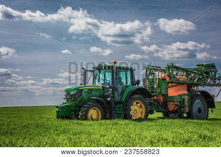Varna Region, Bulgaria - April 19, 2019: A Modern John Deere 6120m Tractor On A Green Field.the 6120