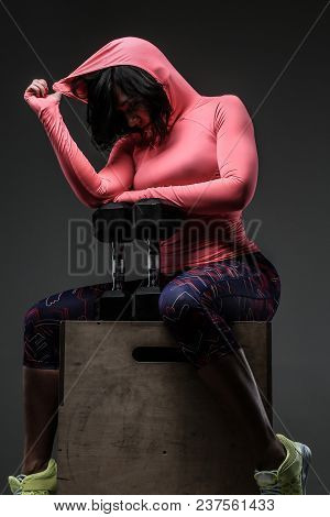 Attractive Fitness Woman In Sportswear Posing With Dumbells In Sudio On Grey Background
