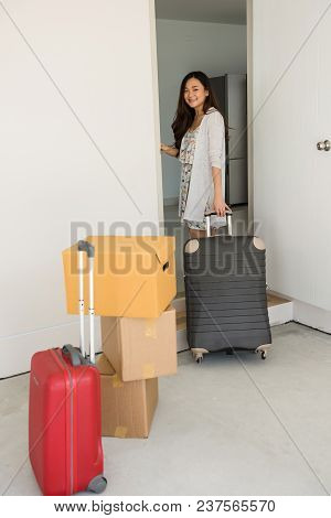 Portait Of Smile Asian Woman Moving To New House With Many Luggaage And Cardboard Boxes At Front Doo