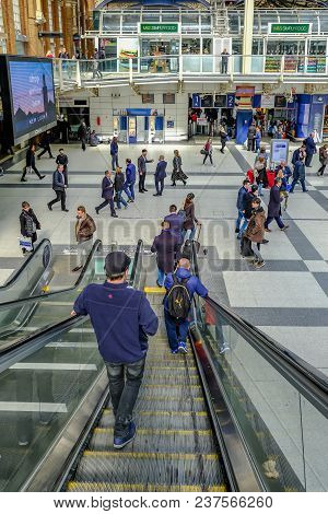 Liverpool Street Station, London, Uk - April 6, 2018: Going Down The Escalator At The Entrance To Li