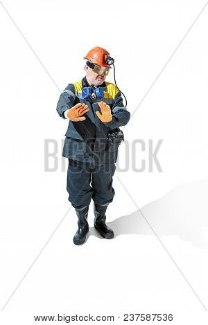 Studio Shot Of Contemptuous Senior Bearded Male Miner In Professional Helmet Standing At The Camera 