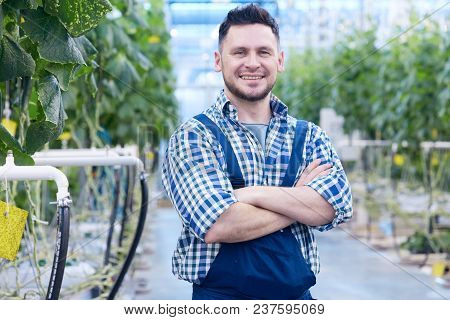 Waist Up Portrait Of Cheerful Plantation Worker Posing Standing With Arms Crossed And Looking At Cam