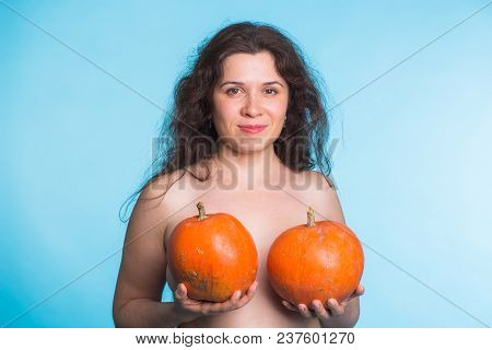 Plastic Surgery Concept - Woman Breast Pumpkins Implant Upsize Metaphor.