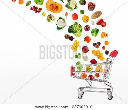 Grocery Cart With Vegetables And Fruits Falling In It Isolated On White. Healthy Meals Shopping, Cor