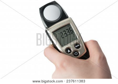 Hand Holding Light Exposure Meter, A Photograph Device For Measuring Illumination On White Backgroun