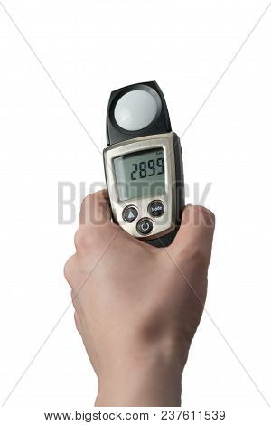 Hand Holding Light Exposure Meter, A Photograph Device For Measuring Illumination On White Backgroun