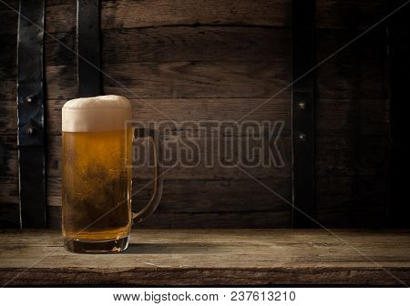 Oktoberfest Beer Barrel And Beer Glasses With Wheat And Hops On Wooden Table.