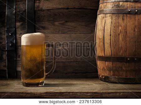 Oktoberfest Beer Barrel And Beer Glasses With Wheat And Hops On Wooden Table.