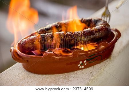 Traditional Portuguese Chourico Or Spanish Chorizo Prepared In A Special Clay Pot