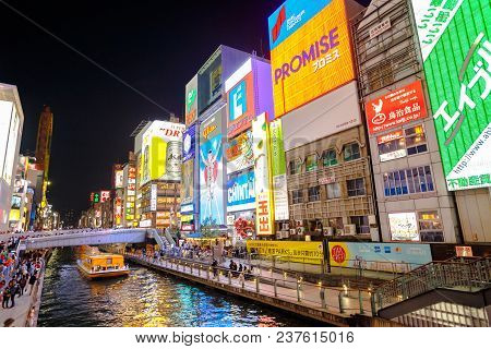 Osaka, Japan - April 29, 2017: Night Urban Scene. Touristic Boat In Dotonbori Canal And Famous Glico