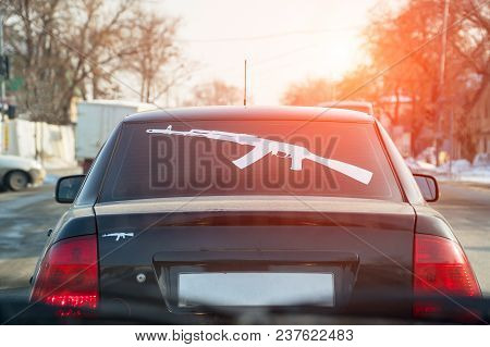 Figure Kalashnikov Rifle On The Rear Window Of The Car