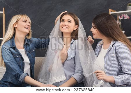 Girl Preparing For Wedding And Showing Bridal Veil To Her Friends. Celebration, Henparty Before Wedd