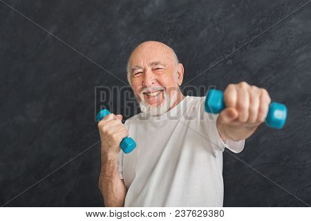Senior Fitness Man Training With Dumbbells At Gym, Doing Strength Exercise For Biceps, Black Backgro