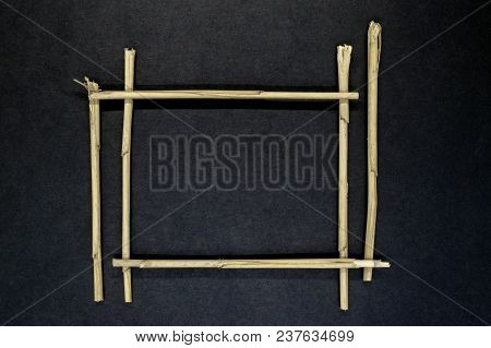 Frame From Reed Bents Straw On Black And Partly Blue Background Surface With Free Space