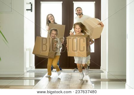 Excited Kids Holding Boxes Running Entering Into New Big House, Cute Children Boy And Girl Carrying 
