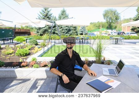Freelancer Working With Papers And Laptop, Enjoying Virtual Reality Glasses In Open Air . Conceptof 
