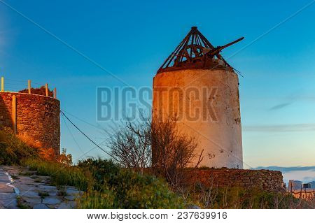 White Windmill On A Hill Above The City Chora On Sunset. Mykonos. Greece. Chora.
