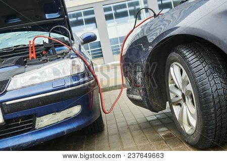 Automobile help. booster jumper cables charging automobile discharged battery
