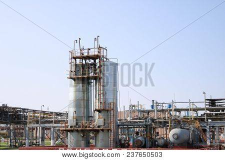 Two Huge High Metal Tanks, Barrels, Heat Exchanging Equipment, Pumps, Pipes In The Oil Refinery, Pet