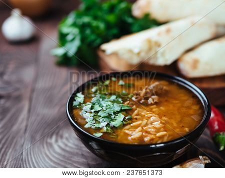 Traditional Georgian Kitchen-soup Kharcho With Meat, Rice And Fresh Cilantro. Spicy Soup Kharcho On 