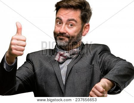 Middle age man, with beard and bow tie confused with thumbs up and down, trying to take a decision expressing doubt and frustration isolated over white background