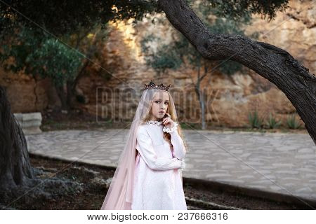 Charming Whute Witch Foreteller Stands In A Mysterious Magical Forest In A Wedding Dress With A Veil