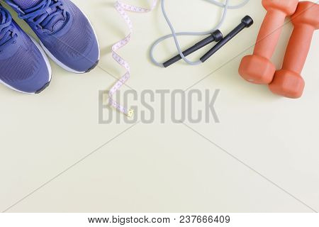 Fitness Background With Place For Text. Blue Sneakers, Dumbbells, Skipping Rope And Tape Measure. Mo