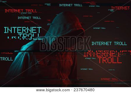 Internet Troll Concept With Faceless Hooded Male Person, Low Key Red And Blue Lit Image And Digital 