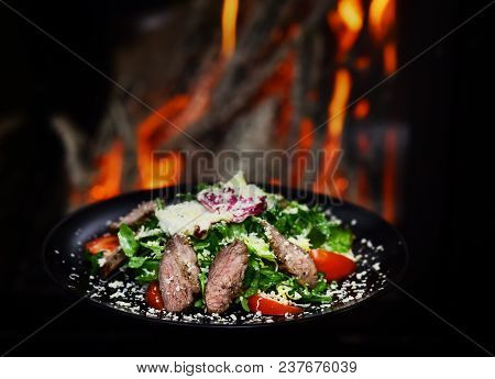 Dish Of Beef Or Veal Served With Lettuce Leaves, Tomatoes And Sprinkled With Parmesan Cheese, Fire O
