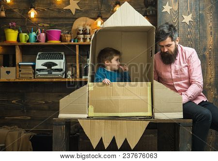 Boy Play With Dad, Father, Little Cosmonaut Sit In Rocket Made Out Of Cardboard Box. Rocket Launch C