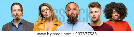 Group of mixed people, women and men expressing love, blows kiss at camera, flirting